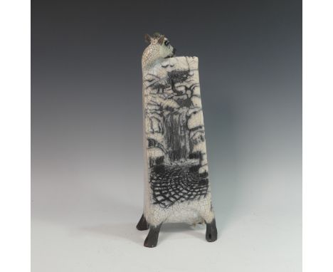 Lawson E. Rudge (b. 1936), a raku fired studio pottery sculpture of an elongated Cow, with waterfall design to one side, numb