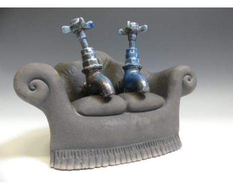 Lawson E. Rudge (b. 1936), a studio pottery sculpture of Taps on a Sofa, one tap broken and repaired, W 28cm x D 16cm x H 21c