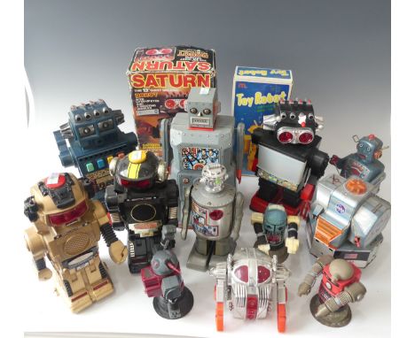 A Boxed Saturn the 13" Giant Walking Robot, battery powered with a collection of unboxed tinplate and plastic Robots and a ti