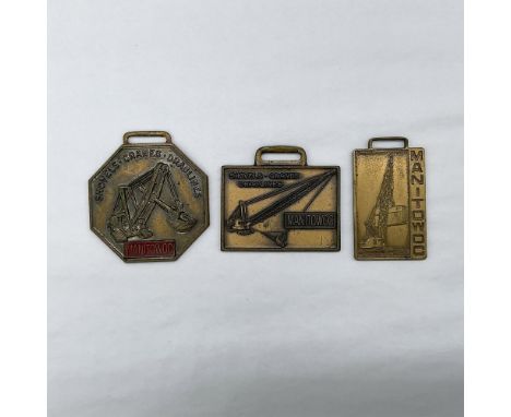 Metal finish with embossed design and lettering. First fob, octagon shaped, front side: Manitowoc - Shovel, Cranes, Draglines
