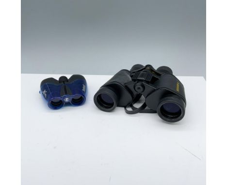 Charming duo of tools used for magnifying includes a compact blue Bushnell 8x21 with a case and a wide angle Bushnell 15x35. 