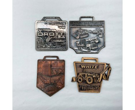 Metal finish with embossed design and lettering. First fob front view: Drott; reverse side: Groff Tractor &amp; Eqt. - Mechan