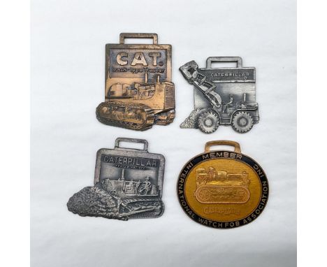 Metal finish with embossed design and lettering. First fob front view: CAT Track-Type Tractor; reverse side: blank. Second fo