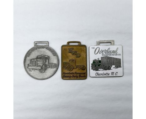 Metal finish with embossed design and lettering. First fob, pewter-colored finish, front view: Diamond Reo Trucks; reverse si