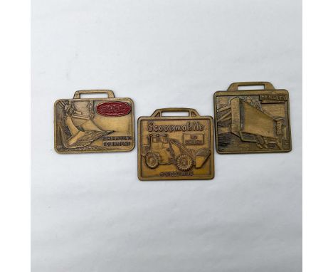 Metal finish with embossed design and lettering. First fob front and reverse view: ESCO in red enamel, Earthmoving Equipment.