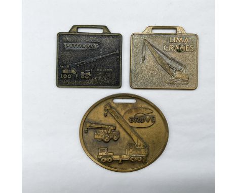 Metal finish with embossed design and lettering. First fob front side: Pettie Bone Truck Krane; reverse side: blank. Second f