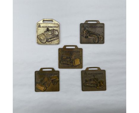 Metal finish with embossed design and lettering. All five fobs front side features various industrial vehicles. First fob rev