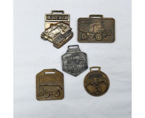 Metal finish with embossed design and lettering. First fob front view: Euclid, depicting a dozer; reverse side: Euclid TC-12.