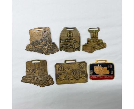 Metal finish with embossed design and lettering. All six fobs front side features embossed images of various industrial const