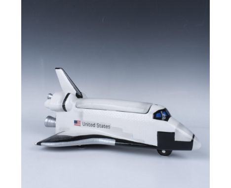 Black and white replica of the space shuttle. Lid is removable to store goodies. United States and the flag prominently shown