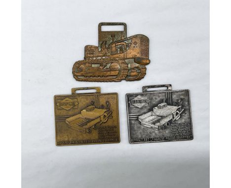 Metal finish with embossed design and lettering. First fob front side: an emboss image of an Allis Chalmers tractor; reverse 