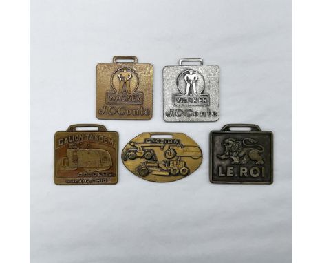 Metal finish with embossed design and lettering. First and second fob front side: Wacker J.C-Conte; reverse side: blank. Thir