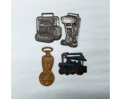 Metal finish with embossed design and lettering. First fob front view: Caterpillar Reg. US PAT Off., featuring a tractor; rev