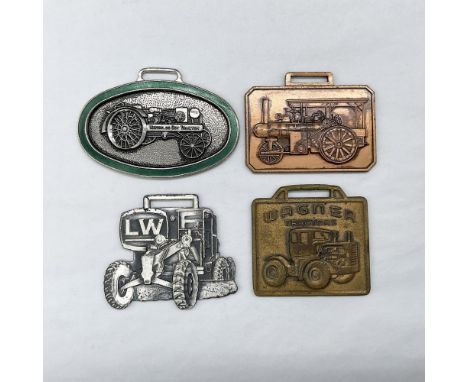 Metal finish with embossed design and lettering. First fob, with green enamel, front view: an embossed image of a Waterloo Bo