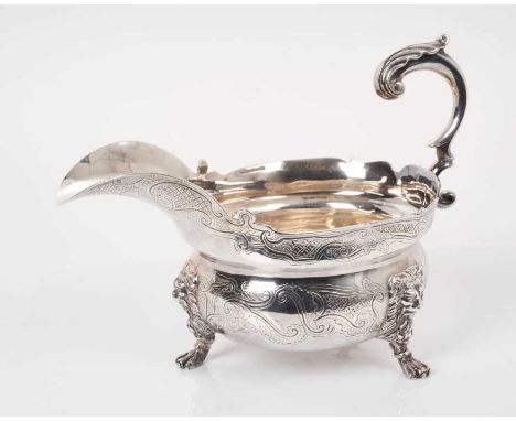 Fine quality contemporary silver sauce boat, in the Georgian style, with engraved decoration and open scroll leaf mounted han