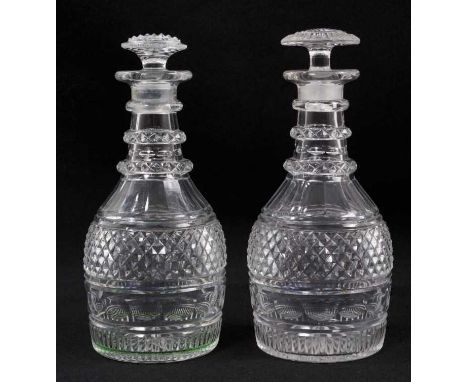 A near pair of Georgian cut glass three-ring decanters, with diamond and facet-cut patterns, mushroom stoppers, 20.5cm and 21