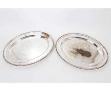 Contemporary silver plated tray of oval form, with heavy gadrooned border and dished centre, underside stamped Harrods London