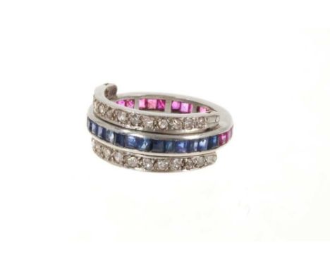 A ruby, sapphire and diamond eternity swivel ring, the main band channel set with calibré cut blue sapphires on one side and 