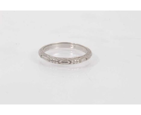 Art Deco platinum wedding ring with carved decoration. Ring size IShank stamped 'PLAT'. Weight 2.8 grams 