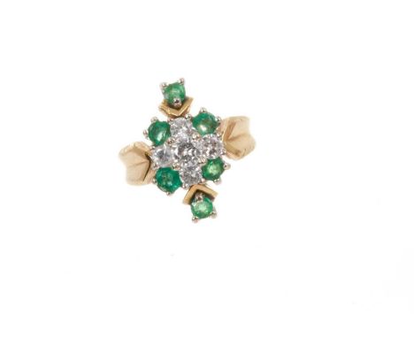 Emerald and diamond cluster ring with four central brilliant cut diamonds surrounded by six round mixed cut emeralds in claw 