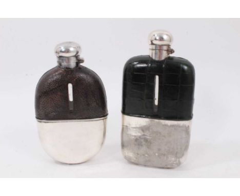 Two early 20th century hip flasks, the first clad with green crocodile leather, 18cm high, the other initialled to the cover,