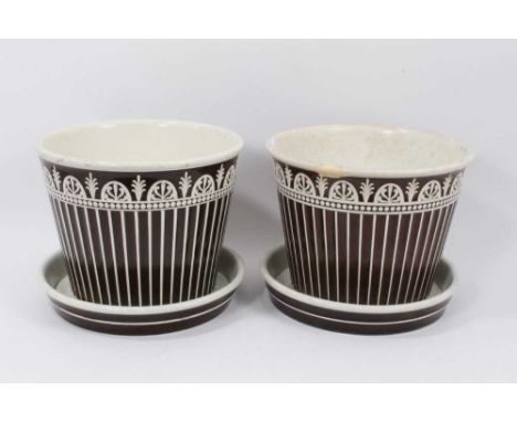 A pair of large early 19th century Wedgwood cache pots and stands, of round fluted form with classical design to border on a 
