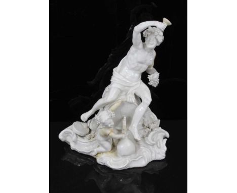 An 18th century Italian porcelain group of Bacchus, in the white, modelled astride a barrel, with a cherub at his feet pourin