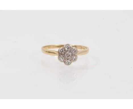 Diamond flower head cluster ring with seven single cut diamonds in platinum setting on 18ct yellow gold shank. Ring size L½-M