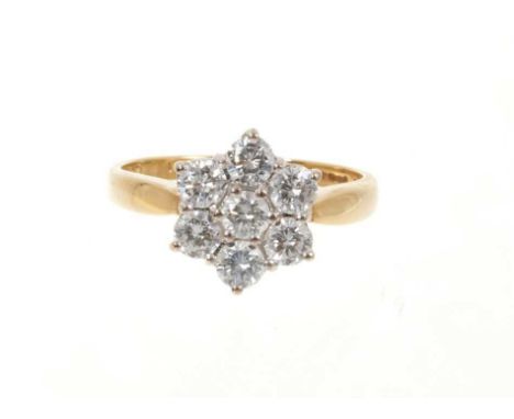 Diamond cluster ring with a daisy cluster of seven brilliant cut diamonds in claw setting on 18ct yellow gold shank. Estimate