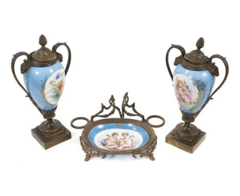 A pair of late 19th century Sèvres bronze-mounted cassolettes, and a similar dish, decorated with cherubs and flowers on a bl