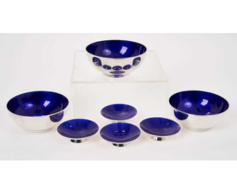 A set of three Danish modernist silver dishes of deep circular form, with blue enameled interiors, by Anton Michelsen, unders