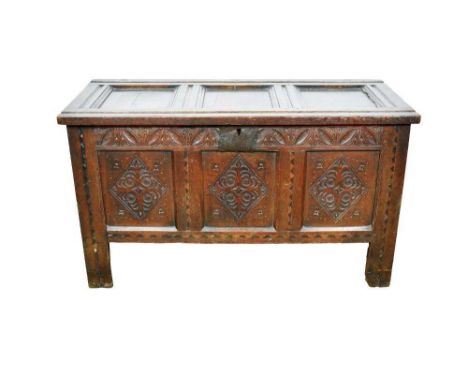 Good 17th century carved oak and dog tooth inlaid coffer, with panelled lid and carved frieze over triple panel carved front 