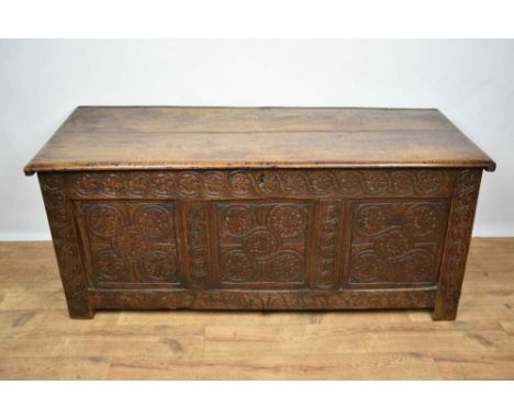 18th century carved oak coffer, with hinged plank lid and triple panel carved front, later elements, 135cm wide x 55cm deep x
