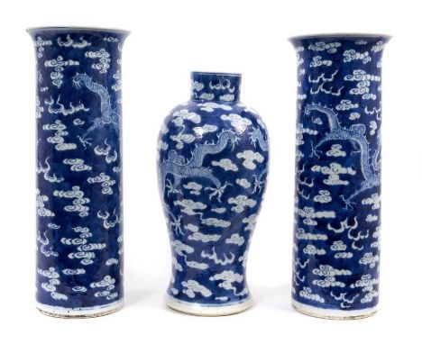 A garniture of Chinese blue and white porcelain vases, late 19th century, each decorated with dragons chasing a flaming pearl