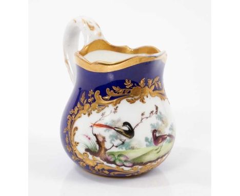 A Sevres cream jug, 18th/19th century, polychrome painted with birds, raised gilt decoration on a cobalt blue ground, interla