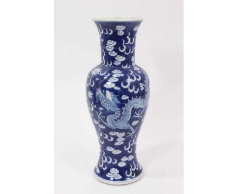 A Chinese blue and white porcelain vase, circa 1900, decorated with dragons chasing a flaming pearl, double ring mark to base