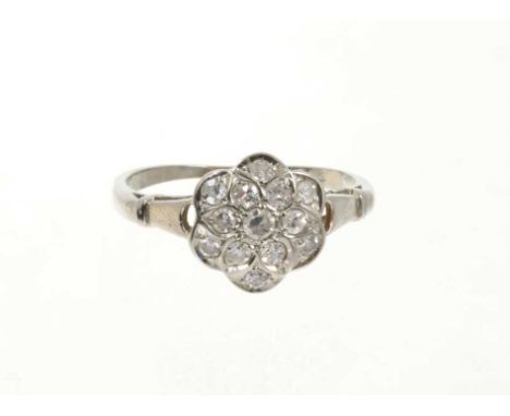 Diamond cluster ring with a flower head cluster of thirteen single cut diamonds on 18ct white gold shank. Ring size O½Shank i