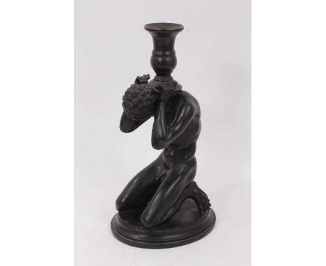 Regency style plaster and bronze figural candlestick, in the form of Atlas holding aloft a bronze sconce, 26cm high. Provenan