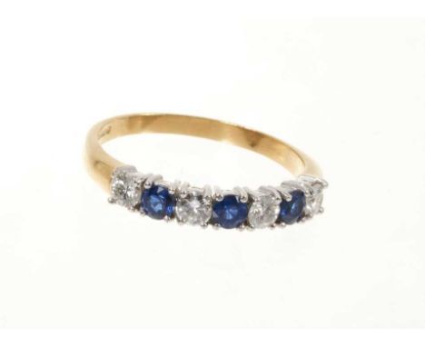 Sapphire and diamond eternity ring with a half hoop of four round brilliant cut diamonds interspaced by three round mixed cut