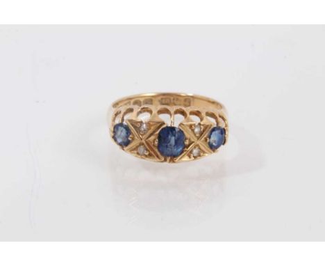 Edwardian 18ct gold sapphire and diamond ring with three oval mixed cut blue sapphires and four rose cut diamonds in 18ct gol