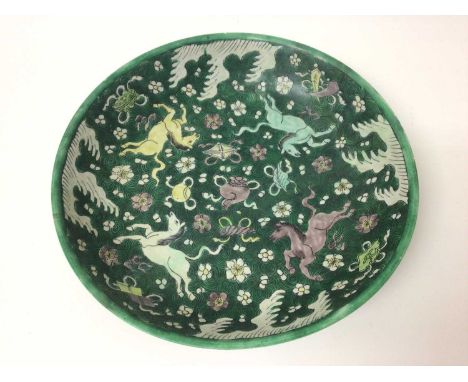 A rare Chinese Qing famille verte biscuit porcelain dish painted with yellow, green and aubergine horses, precious objects, w