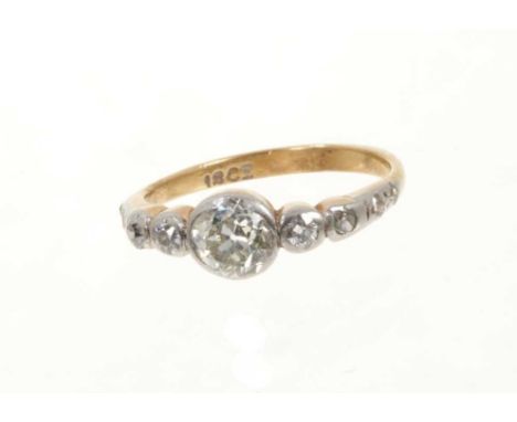 Edwardian diamond ring with an old cut diamond estimated to weigh approximately 0.50cts in rub-over setting flanked by gradua