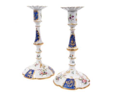 Good pair of 18th century Bilston enamel candlesticks, decorated in floral sprigs and gilt and royal blue reserves, having re