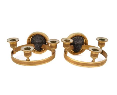 Pair of Empire bronze and ormolu three light wall appliqués, with lion mask boss wall mount supporting tooled projecting ring