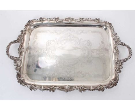 Large late Victorian silver two handled tea tray of rectangular form with engraved decoration and foliate scroll borders (She