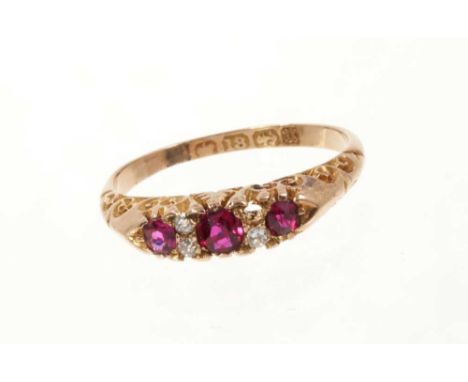 Victorian ruby and diamond ring with three round mixed cut rubies and three old cut diamonds in carved gold setting on 18ct g