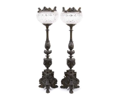 Pair of 19th century bronze candlesticks converted for electricity, each with inverted cut glass bowls, raised on flared colu