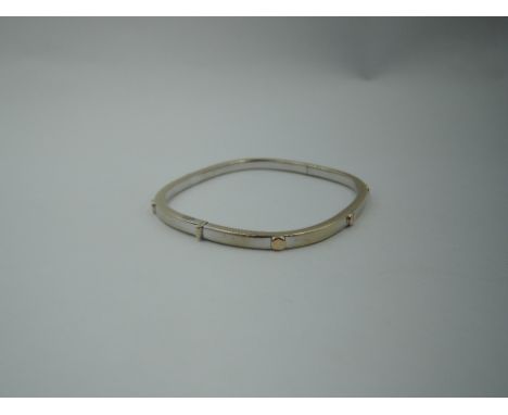 An Italian 18ct white and yellow gold hinged bangle having screw  head style decoration,  approx 11.9g