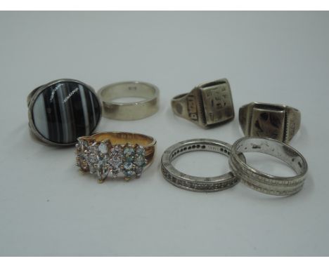 A selection of HM silver and white metal rings including striped agate, Middle Eastern engraved Iraq, Thomas Sabo, band style