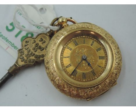 A lady's small yellow metal key wound pocket watch stamped 18K having Roman numeral dial on engraved face in an extensively e